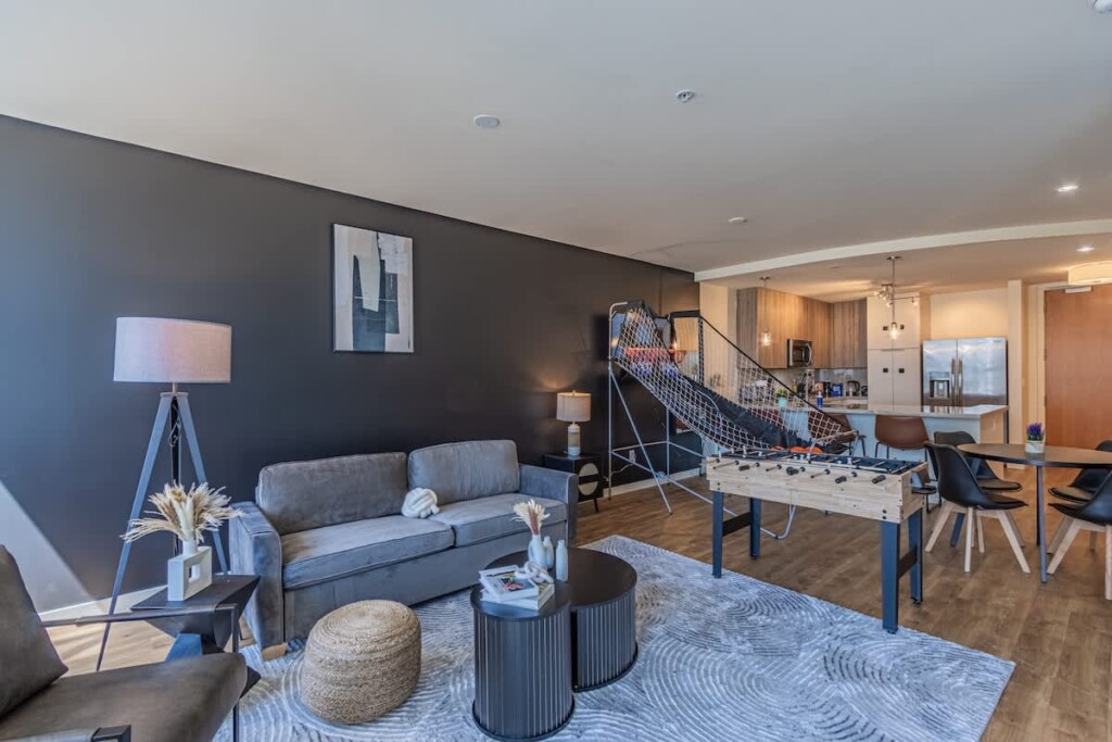 Furnished apartment with living area, dining table and games corner